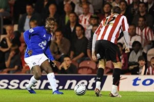 21 September 2010 brentford v everton Collection: Intense Battle: Magaye Gueye vs. Michael Spillane - Everton vs