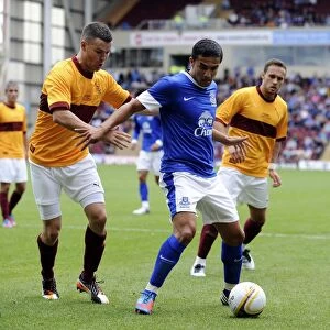 Images Dated 21st July 2012: Intense Clash: Tim Cahill vs. Simon Ramsden - Motherwell v Everton Pre-Season Friendly at Fir Park