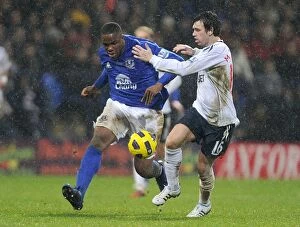 Images Dated 13th February 2011: Intense Rivalry: Anichebe vs. Davies at Reebok Stadium - Everton vs. Bolton Wanderers