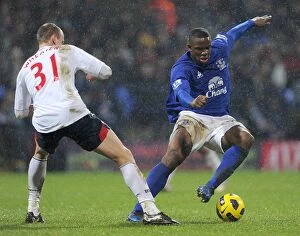 Images Dated 13th February 2011: Intense Rivalry: Anichebe vs. Wheater at Reebok Stadium - Everton vs. Bolton Wanderers