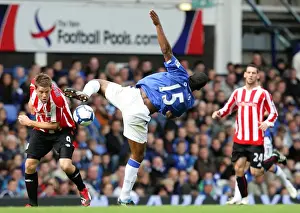 Everton V Stoke City Prints: Intense Rivalry: Distin vs Beattie Battle for Ball at Goodison Park - Everton vs Stoke City