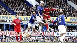 Intense Rivalry: Distin vs. Kyrgiakos Aerial Battle in the Everton vs. Liverpool Premier League Clash (October 2010)