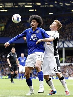 Images Dated 28th April 2012: Intense Rivalry: Fellaini vs Riise - Battle for the Ball at Goodison Park (Everton vs Fulham)