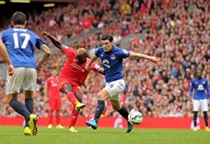 Images Dated 27th September 2014: Intense Rivalry: Gareth Barry Blocks Mario Balotelli's Goal-bound Shot - Liverpool vs