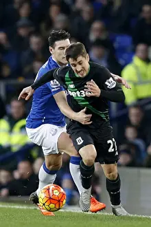 Intense Rivalry: Gareth Barry vs Bojan Krkic - Everton vs Stoke City's Battle for Ball Possession at Goodison Park