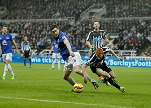 Newcastle United V Everton - St James' Park Prints: Intense Rivalry: Gareth Barry vs Jack Colback Battle at St James Park, Premier League