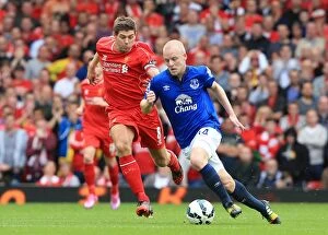 Images Dated 27th September 2014: Intense Rivalry: Gerrard vs. Naismith Battle at Anfield - Liverpool vs. Everton, Premier League