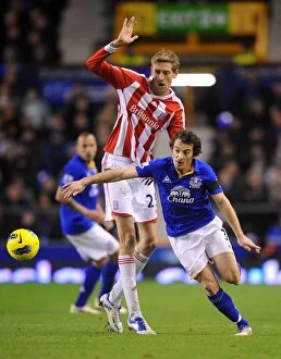 Images Dated 4th December 2011: Intense Rivalry: Leighton Baines vs. Peter Crouch's Battle for the Ball at Goodison Park - Everton