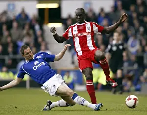 Framed Print : Jagielka vs Sidibe: Intense Clash Between Everton's Jagielka and Stoke's Sidibe in Everton vs Stoke City, Barclays Premier League