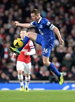 Images Dated 8th December 2013: James McCarthy vs Arsenal: Intense Face-Off at Emirates Stadium in Everton's 1-1 Barclays Premier