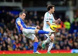 Everton 1 v Chelsea 2 : Goodison Park : 30-12-2012 Collection: Leon Osman vs Juan Mata: Intense Battle for Ball Possession in Everton vs Chelsea Premier League