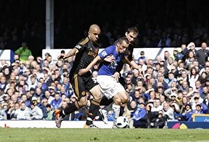 Images Dated 22nd May 2011: Leon Osman's Defiant Stand: Everton vs. Chelsea's Alex and Ivanovic in Intense Barclays Premier
