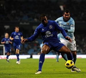 20 December 2010 Manchester City v Everton Collection: Manchester Derby Showdown: Distin vs Tevez - A Football Rivalry