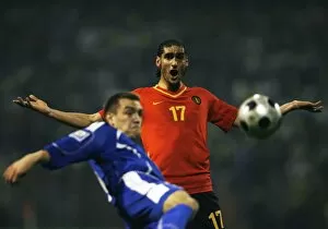 Marouane Fellaini-Bakkioui of Belgium reacts as Boris Pandza of Bosnia kicks the ball during their World Cup 2010