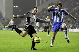 James McFadden Prints: McFadden's Moment of Determination: Everton Star Faces Pressure from Wigan's Arjan De Zeeuw