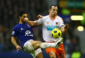 Mikel Arteta vs. Charlie Adam: A Battle for Control in the Everton vs. Blackpool Premier League Clash at Goodison Park (05 February 2011)