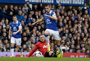 Images Dated 20th April 2014: Mirallas Outmaneuvers Rooney: Everton's Triumph Over Manchester United in the Premier League