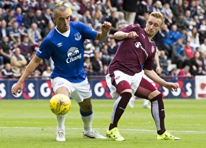 Pre-Season Friendly - Heart Of Midlothian V Everton - Tynecastle Stadium Prints: Osman vs. McKirdy: A Battle for the Ball in Everton's Pre-Season Clash at Tynecastle Stadium