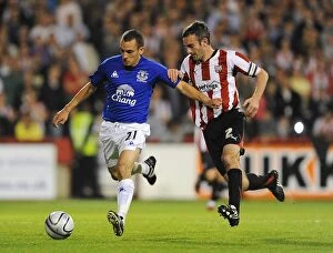 21 September 2010 brentford v everton Collection: Osman vs. O'Connor: A Football Rivalry Ignites in Everton's Carling Cup Showdown at Griffin Park