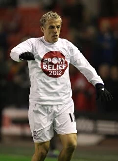 Images Dated 13th March 2012: Phil Neville's Intense Face-Off at Anfield: Liverpool vs. Everton