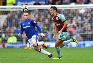 Premier League Prints: Rooney vs Cork: Intense Battle for the Ball at Goodison Park - Everton vs Burnley