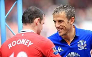 Images Dated 22nd April 2012: Rooney vs Neville: Clash of the Reds - Everton vs Manchester United, Barclays Premier League