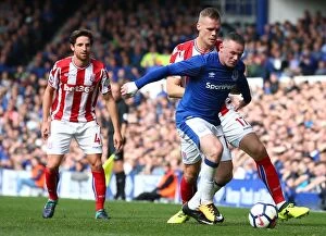 Everton v Stoke City - Goodison Park Collection: Rooney vs Shawcross and Allen: Intense Battle at Goodison Park - Everton vs Stoke City