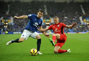 Everton V Leicester City - Goodison Park Prints: Seamus Coleman vs. Paul Konchesky: A Premier League Slide Tackle Showdown at Goodison Park