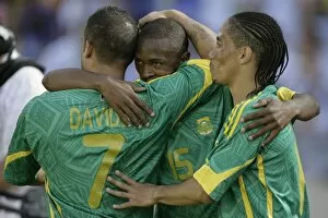 South Africas Parker celebrates with teammates Davids and Pienaar after scoring against Norway during Nelson Mandela