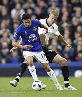 Images Dated 19th March 2011: Tim Cahill Shields Ball from Brede Hangeland: Everton vs Fulham