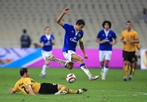 Images Dated 2nd December 2009: Tim Cahill's Epic Leap Over Juanfran: Everton vs AEK Athens in Europa League