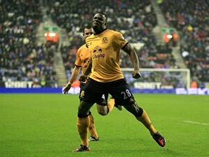 Images Dated 4th February 2012: Victor Anichebe's Thrilling Goal Celebration: Everton's First Goal Against Wigan Athletic in