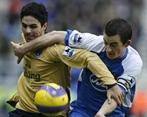 Wigan v Everton Collection: Wigan Athletics Baines challenges Evertons Arteta for the ball during their English Premier League